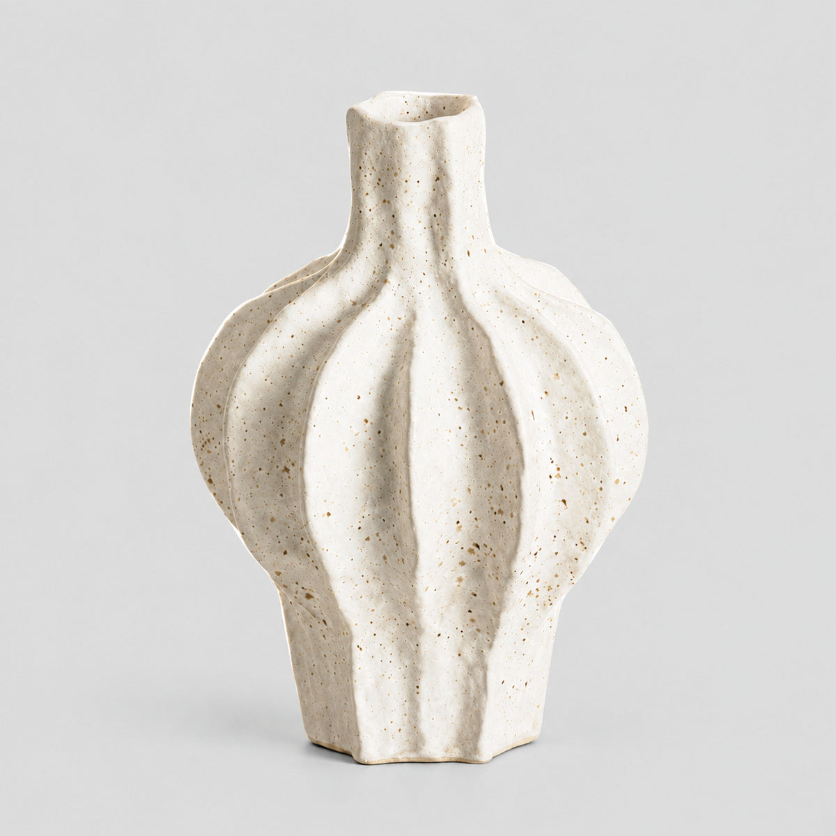 Coarse ceramic fluted vase in Speckled White on a light gray studio background, in its Large Fluted shape