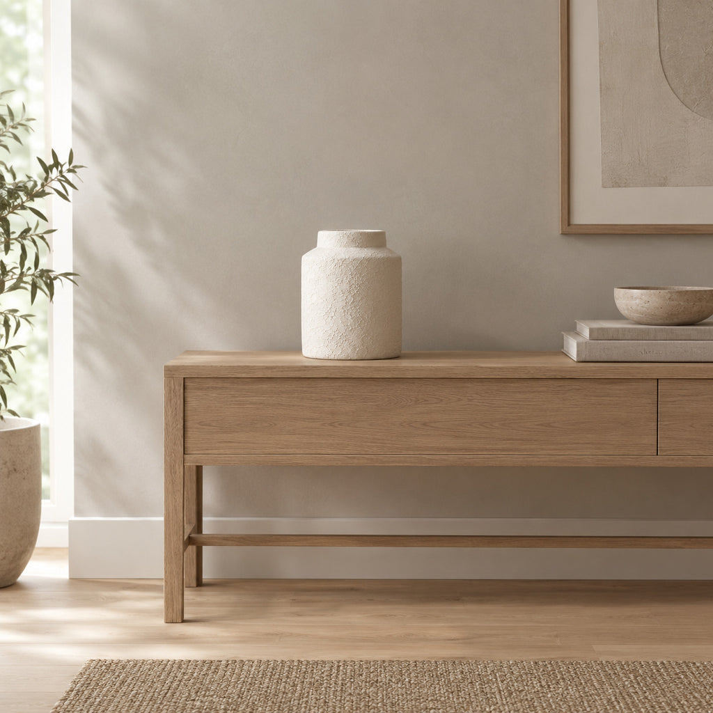 Textured White ceramic jar vase on a 120 cm wide oak console table in a calm room.