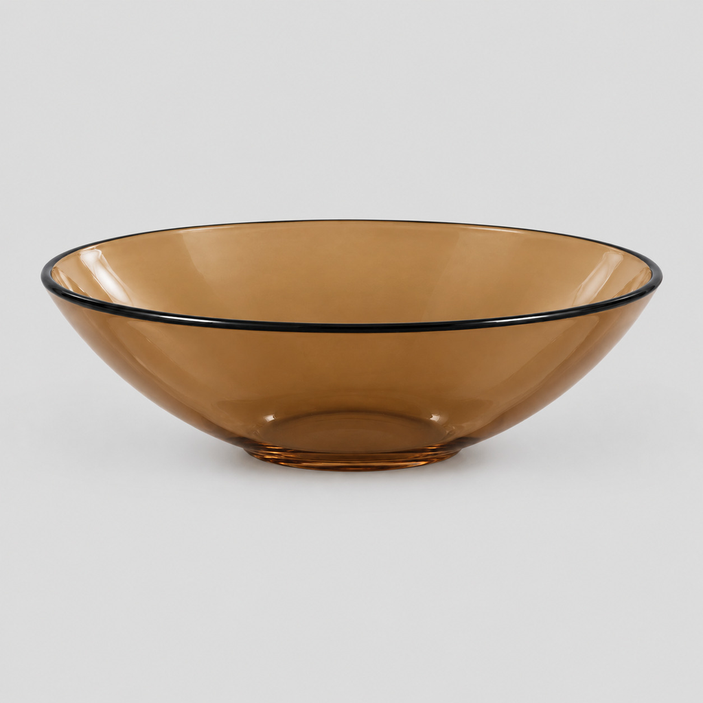 Shallow glass bowl with black rim in Amber on a light gray studio background.