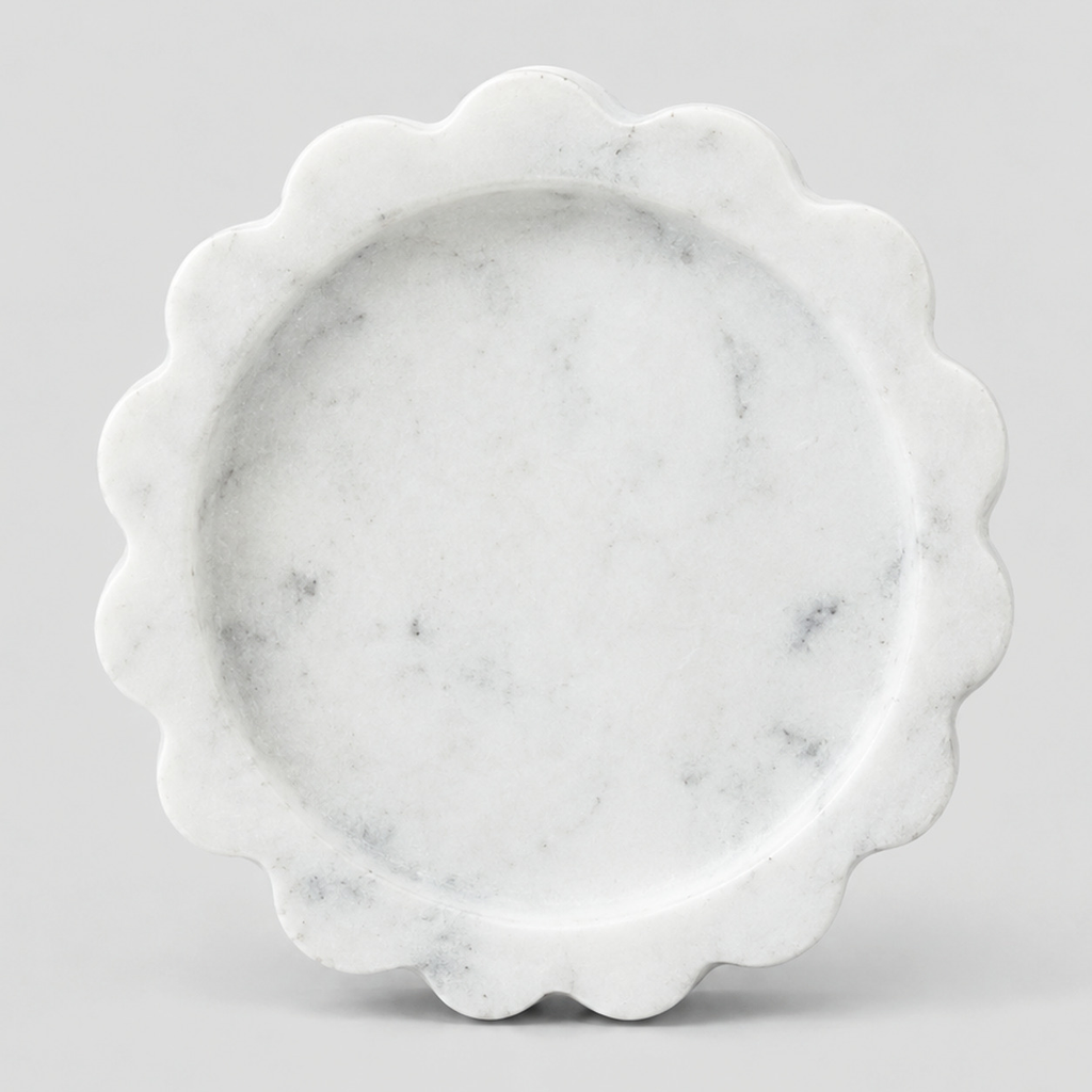 Scalloped stone trinket tray in White Marble on a light gray studio background.