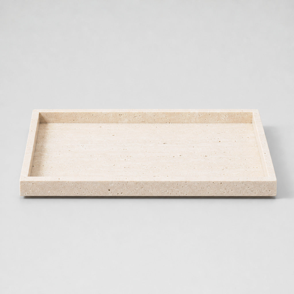 Natural beige travertine rectangular tray in the Beige Travertine finish on a light gray studio background.