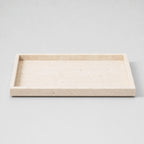 Natural beige travertine rectangular tray in the Beige Travertine finish on a light gray studio background.
