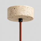 Close up of the round canopy against the wall of the travertine pendant light