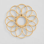 Decorative looped rattan wall frame in Natural Rattan on a light gray studio background.