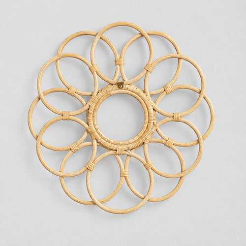 Decorative looped rattan wall frame in Natural Rattan on a light gray studio background.