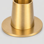 Close up of the flat circular base disc of the brass taper candle holder