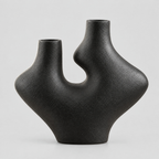 Dual-neck abstract ceramic vase in Matte Black on a light gray studio background