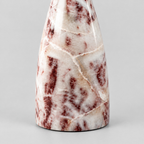 Close up of the solid circular marble base of the Burgundy Marble vase-shaped marble candle holder