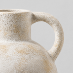 Close up of the curved ceramic handle where it joins the neck of the Vintage Beige ceramic pitcher vase