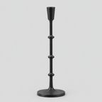 Matte Black cast-iron taper candle holder on a light gray studio background