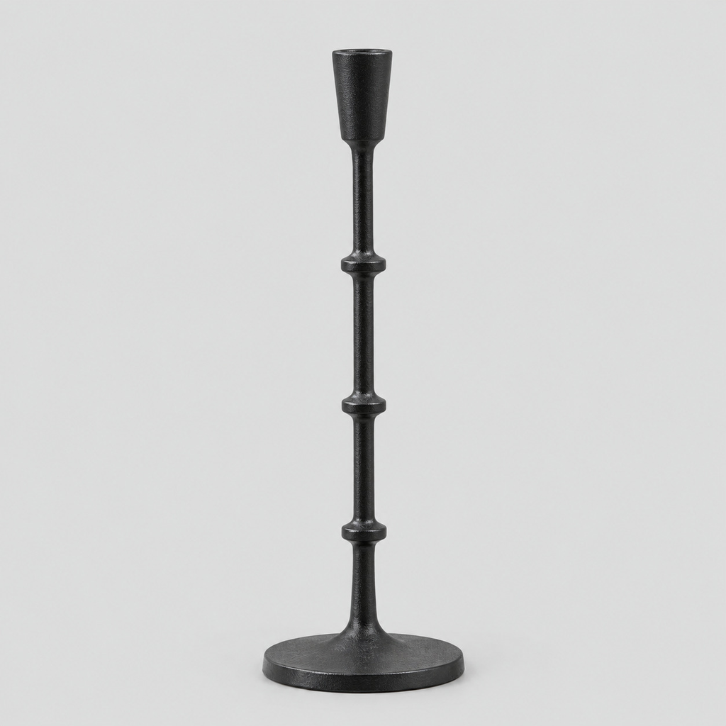 Matte Black cast-iron taper candle holder on a light gray studio background