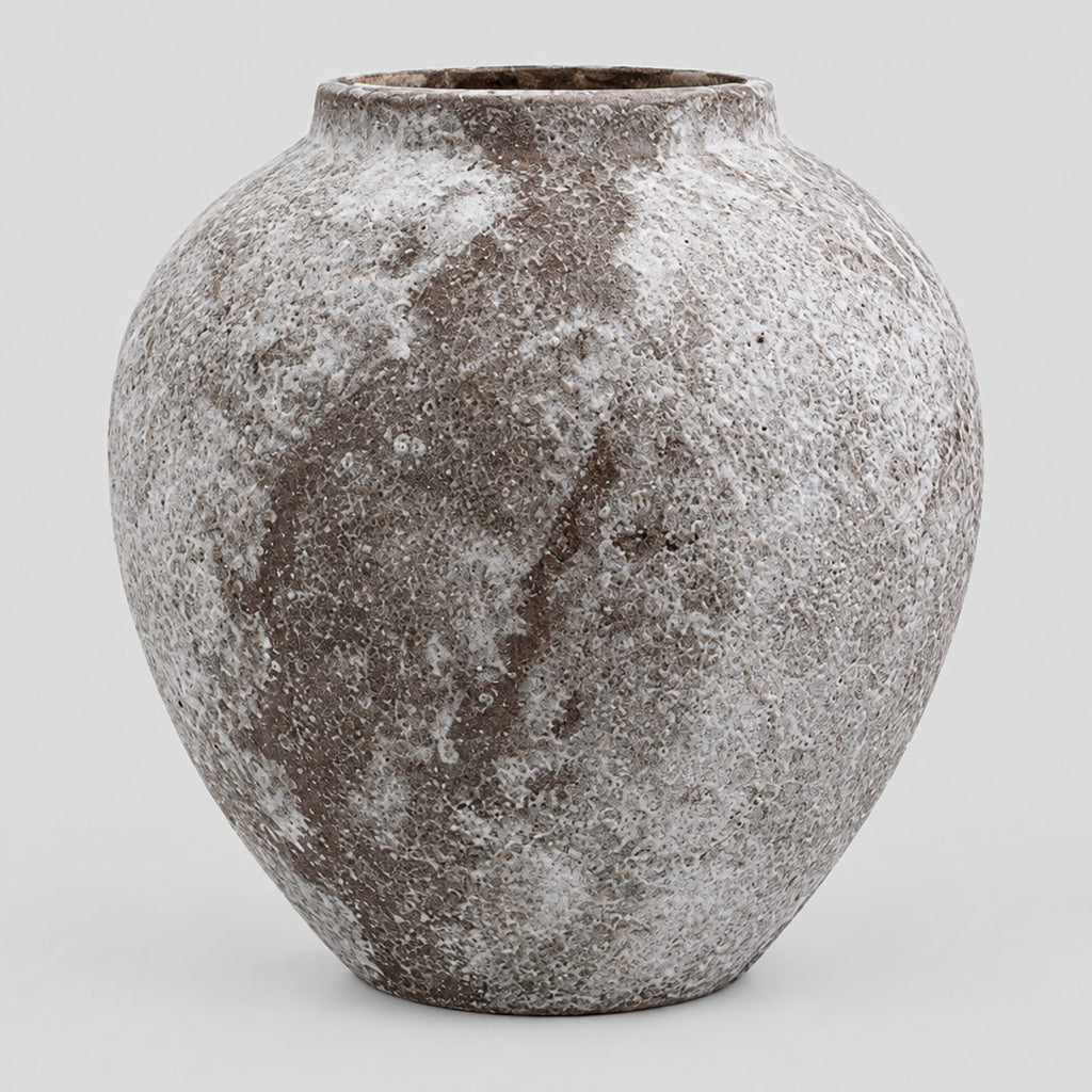 Weathered ceramic vase in Weathered Brown on a light gray studio background.