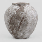 Weathered ceramic vase in Weathered Brown on a light gray studio background.
