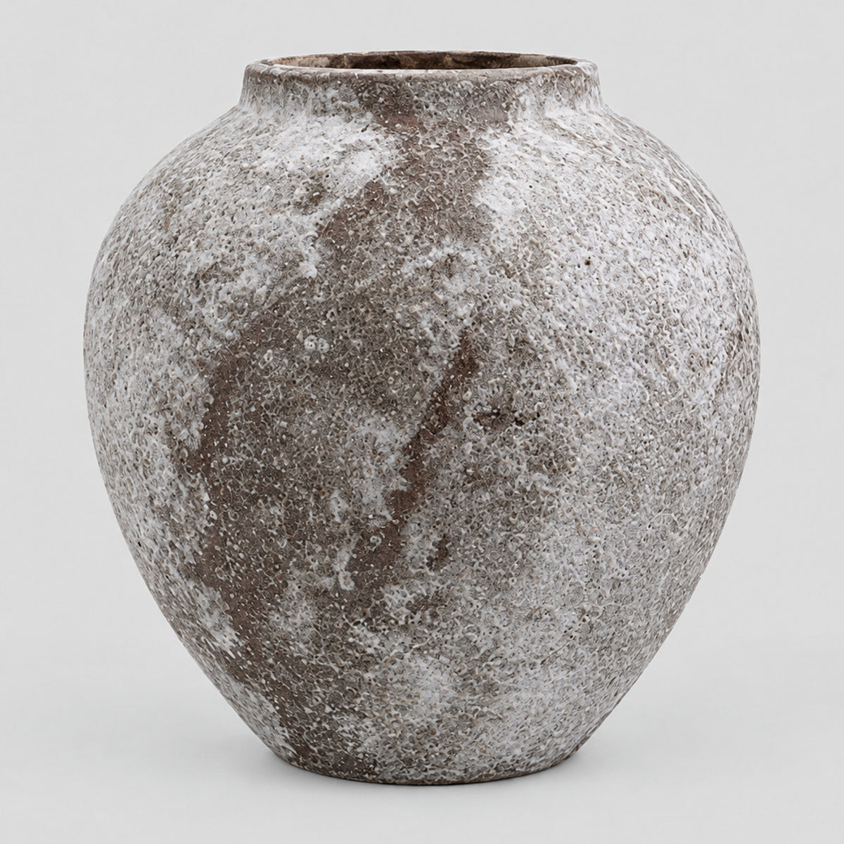 Weathered ceramic vase in Weathered Brown on a light gray studio background.
