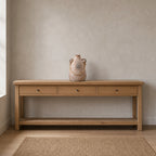 Ribbed ceramic vase with loop handles in Rust on a 120 cm wide oak console table in a calm room.
