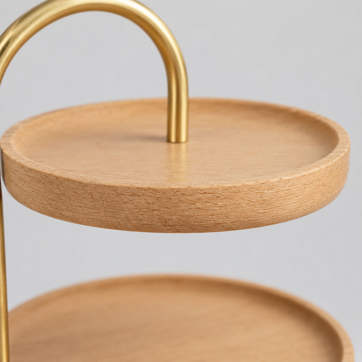 Close up of the rounded wooden rim of the two-tier round wooden serving tray in Beech.