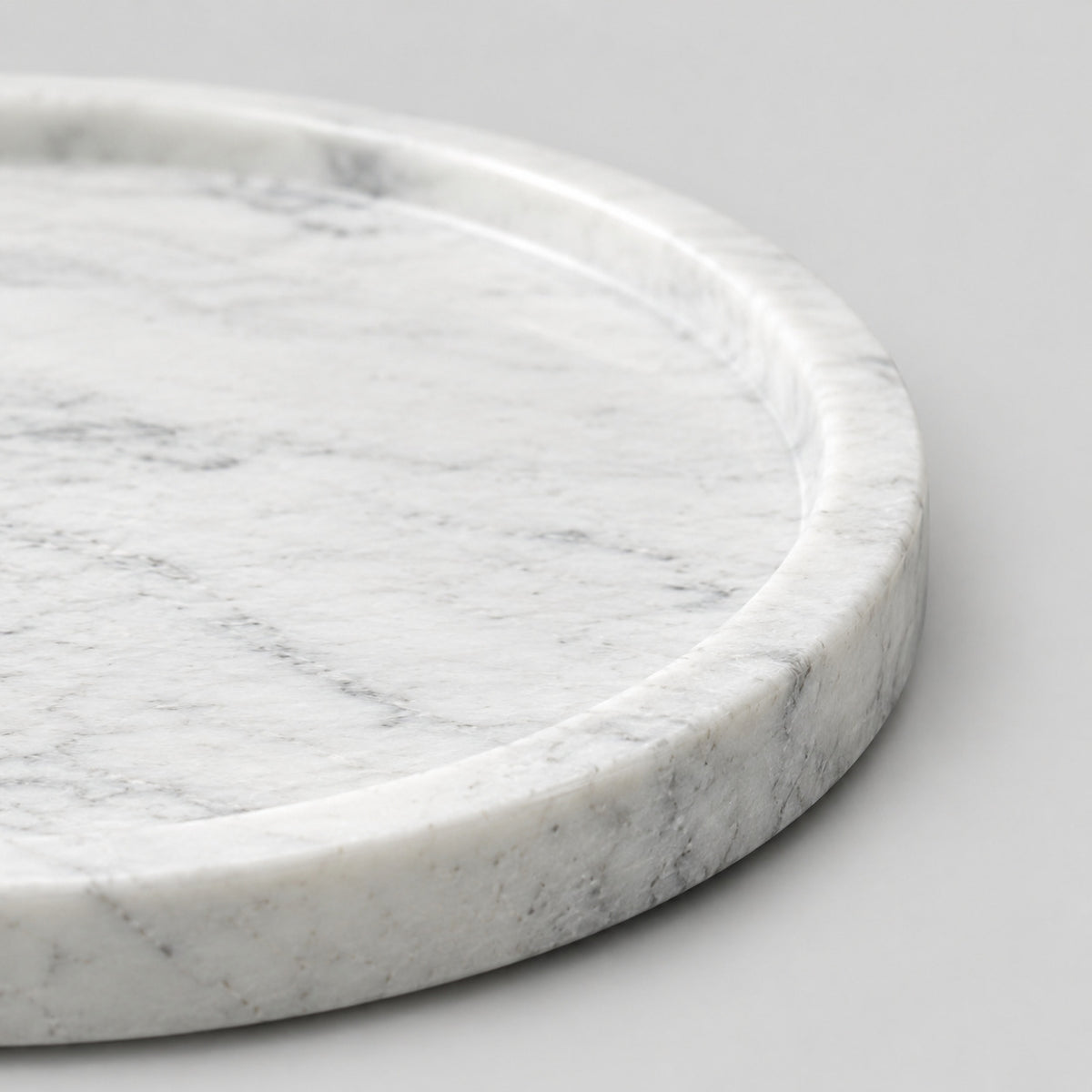Close up of the flat circular base of the round marble tray.