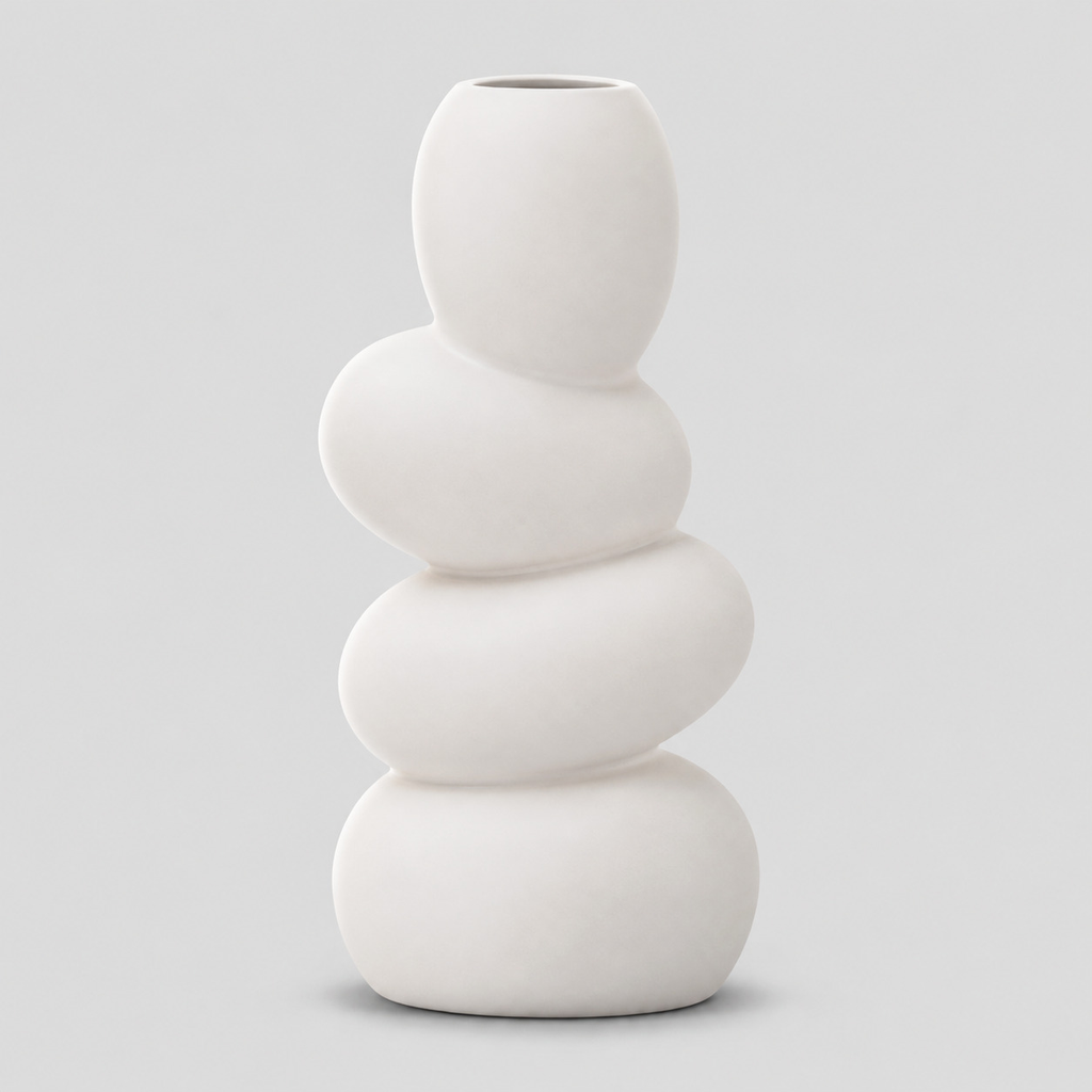 White stacked pebble ceramic vase on a light gray studio background.