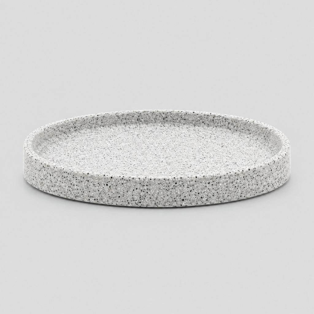 Speckled ceramic catchall tray in Speckled White on a light gray studio background, in its Round shape