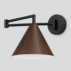 Walnut swing-arm wall sconce with a conical shade and black articulated arm on a light gray studio background.