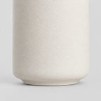 Close up of the smooth unglazed foot at the base of the Off-White matte ceramic bud vase.