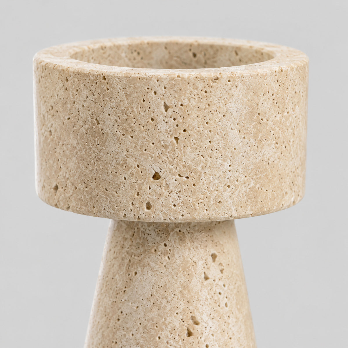 Close up of the porous travertine surface texture of the travertine stone candle holder