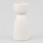 Matte ceramic taper candle holder in Matte White on a light gray studio background.
