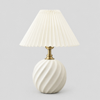 Fluted ceramic table lamp in Milk White on a light gray studio background