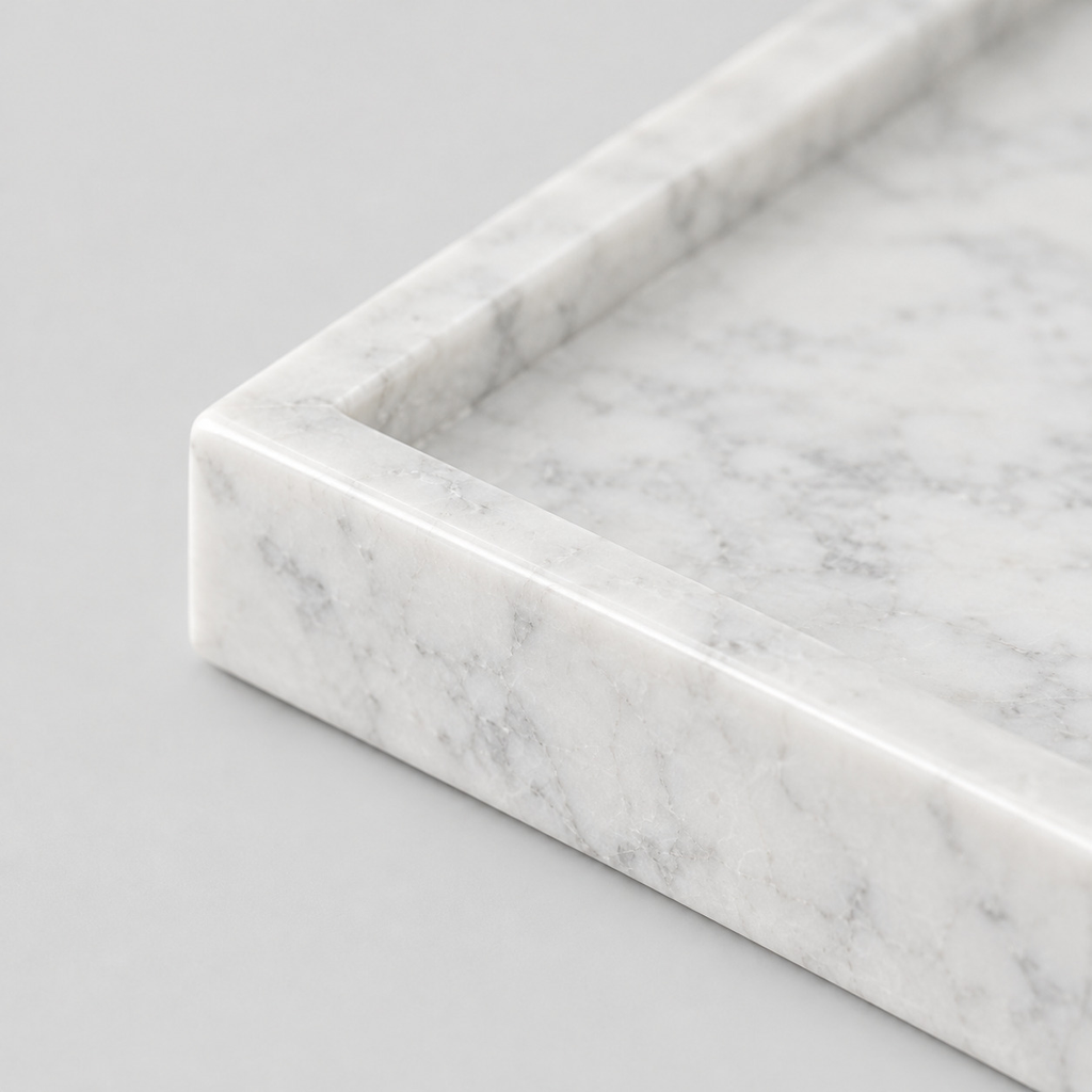Close up of the raised stone rim of the rectangular marble vanity tray in Carrara White