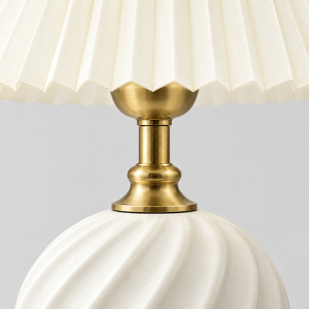 Close up of the brass socket cup holding the bulb seen from the side on the Milk White fluted ceramic table lamp