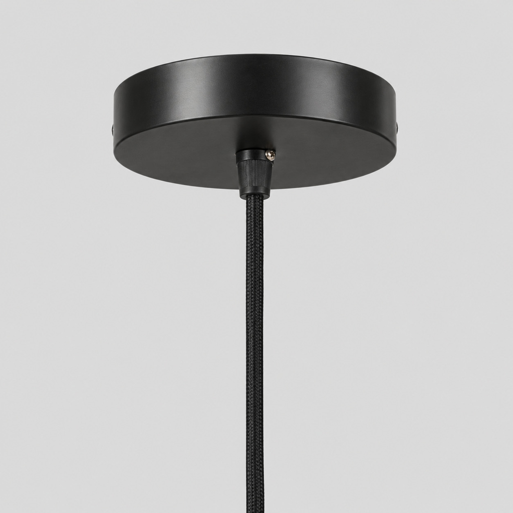 Close up of the round canopy against the wall on the wavy rattan pendant light.