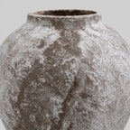 Close up of the textured mottled glaze on the rounded body of the weathered ceramic vase in Weathered Brown.