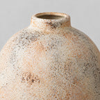 Close up of the textured matte glaze with warm speckling of the ceramic vase.