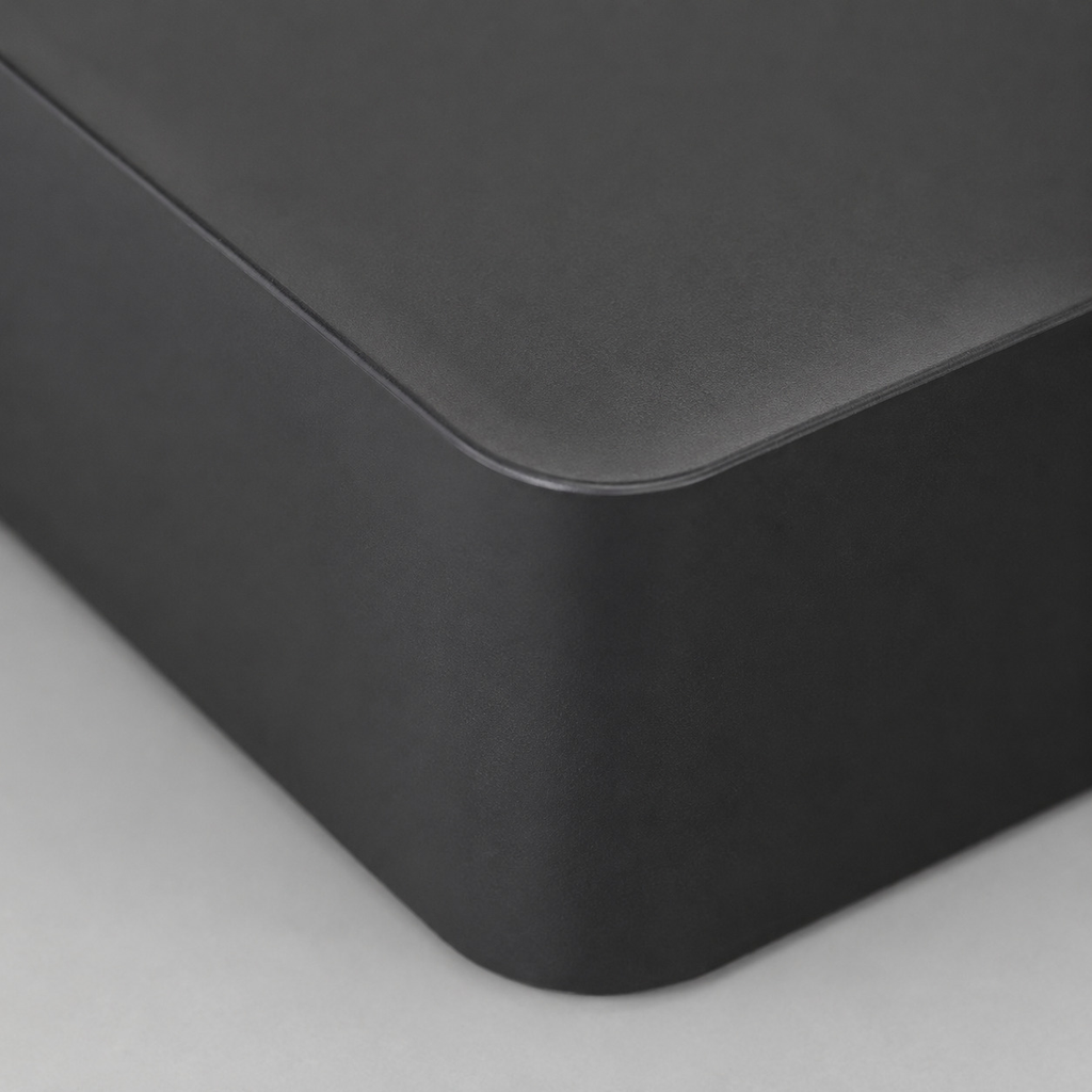 Close up of the smooth matte surface texture of the black square tissue box cover base.