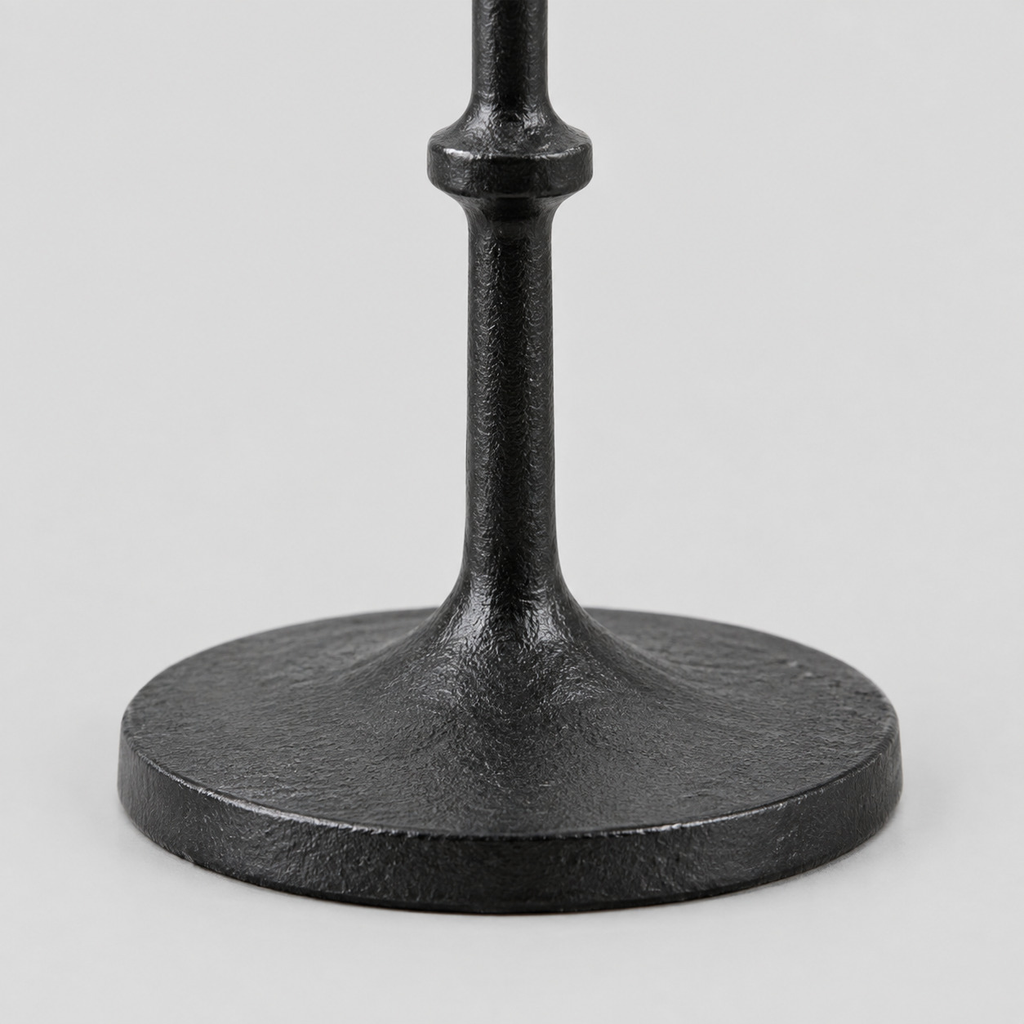 Close up of the circular cast-iron base of the Matte Black cast-iron taper candle holder