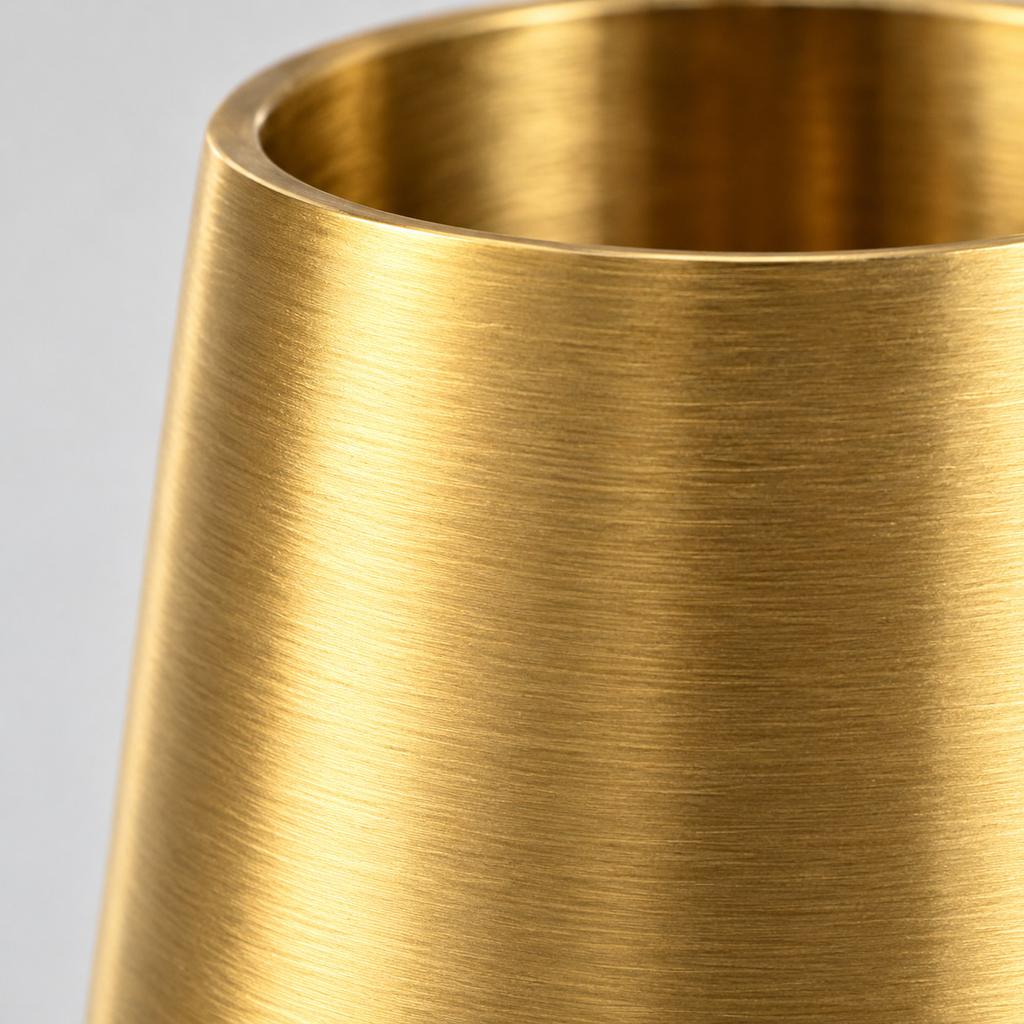 Close up of the brushed surface texture of the tapered cup on the brushed brass taper candle holder.