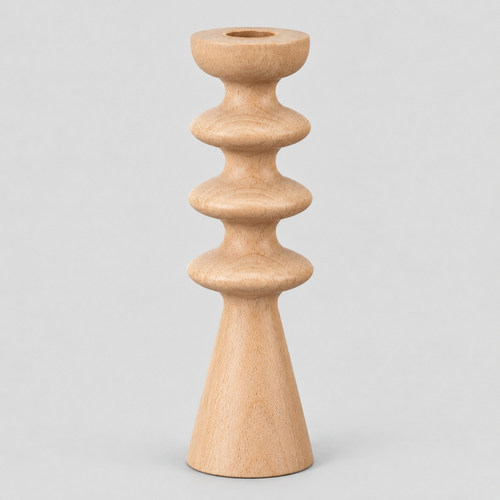 Natural beech turned beechwood taper candlestick on a light gray studio background