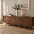 Ribbed barrel ceramic vase in Distressed White on a 160 cm wide walnut sideboard beneath a framed print with a bunch of eucalyptus in the vase.