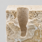 Close up of the carved candle slot of the travertine candle holder