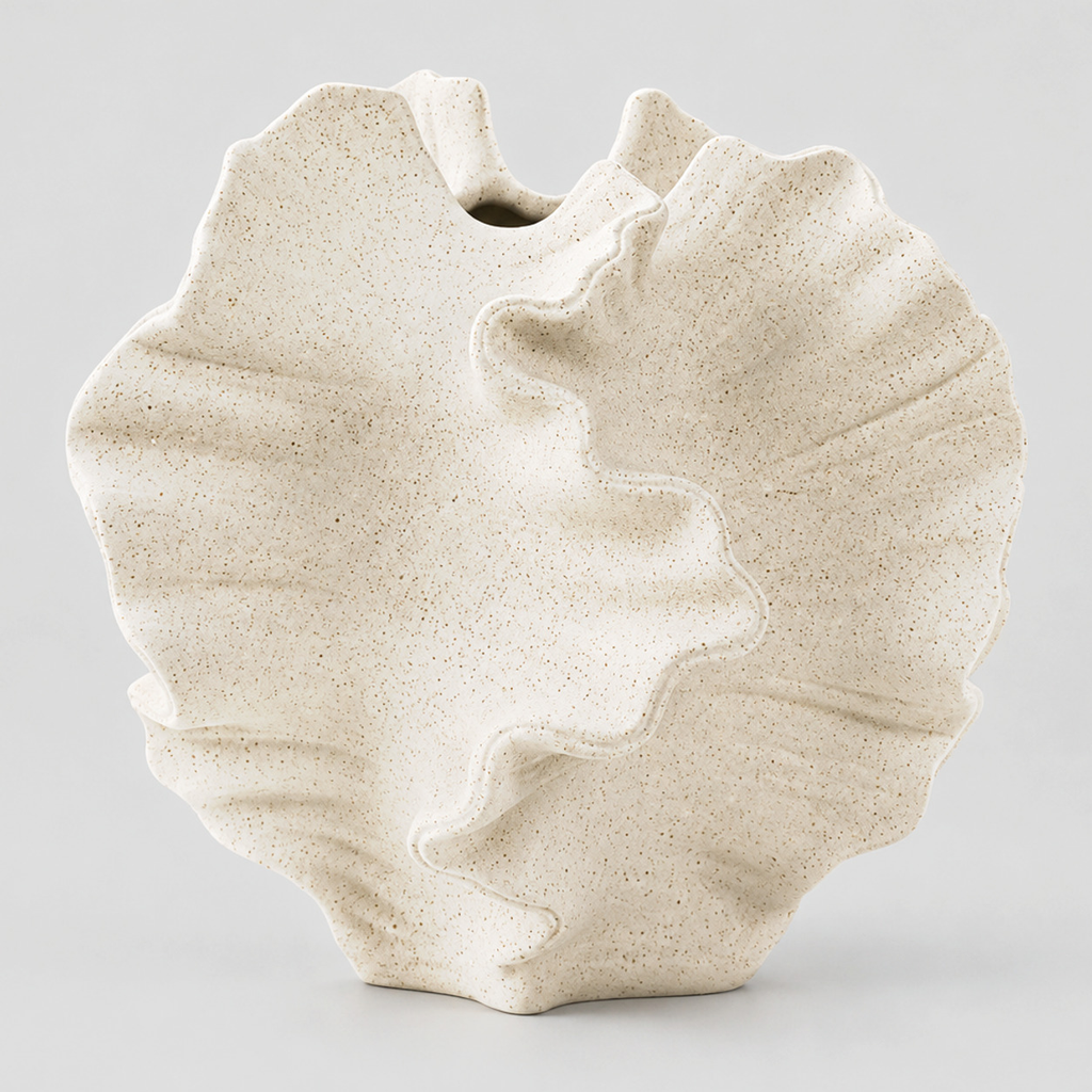 Sculptural ceramic ruffled wave vase in Speckled White on a light gray studio background