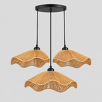 Wavy woven rattan pendant light in Natural Rattan on a light gray studio background, in the 3 lights configuration