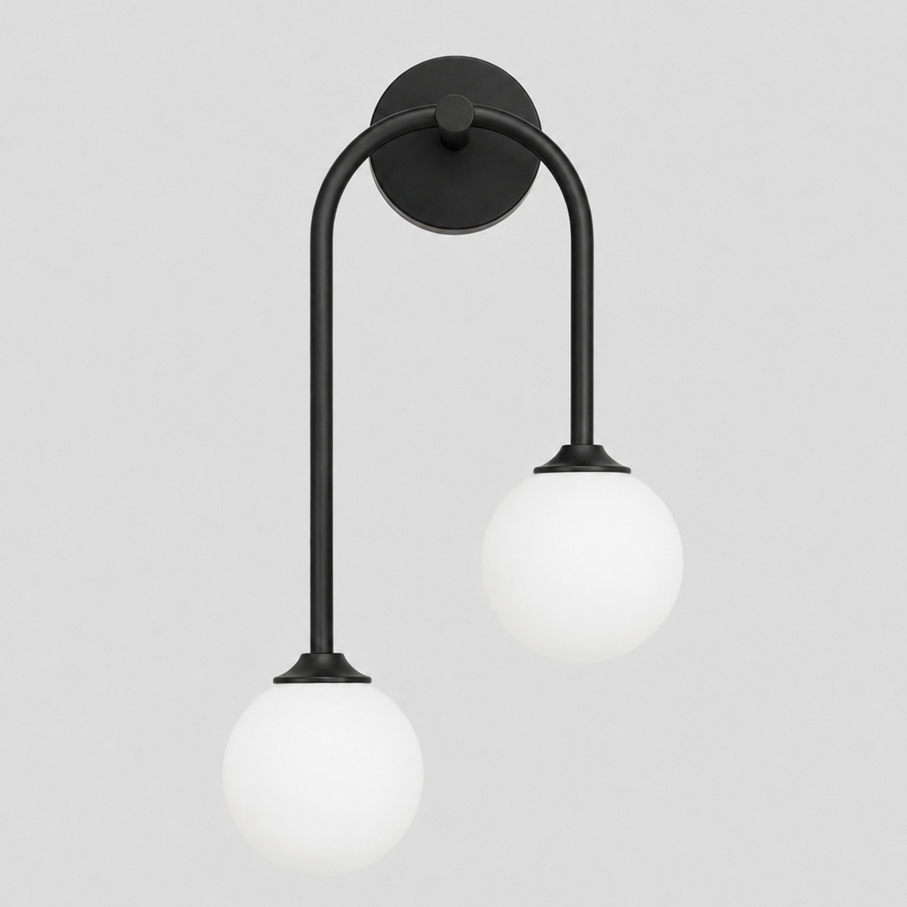 Matte Black asymmetric double-globe arch wall sconce switched off on a light gray studio background, in its Right shape