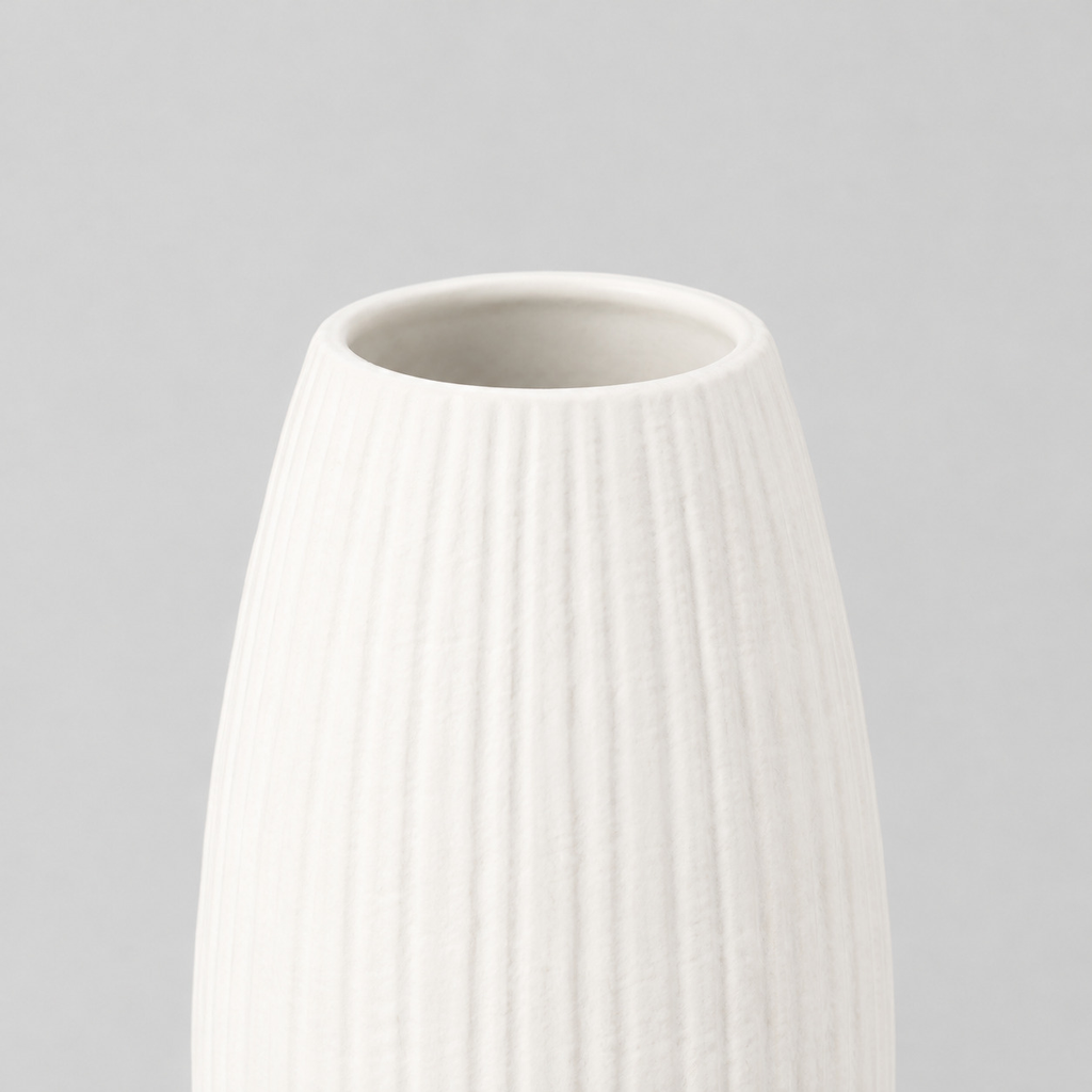 Close up of the smooth rounded rim of the matte white ceramic vase