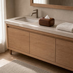 Walnut rounded wooden tissue box cover on a 90 cm wide bathroom vanity with a tissue pulled through the top opening.