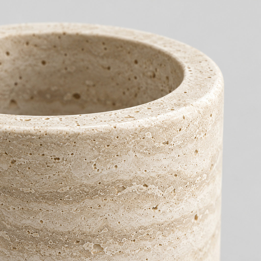 Close up of the smooth rounded stone rim of the natural travertine stone vase