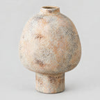 Textured ceramic vase in Speckled Sand finish on a light gray studio background.