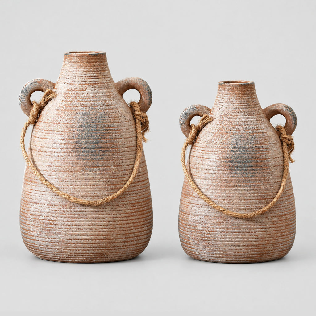 Ribbed ceramic vase with loop handles in Rust on a light gray studio background.