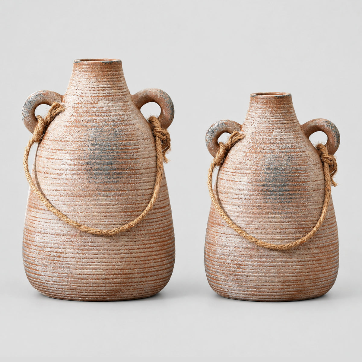 Ribbed ceramic vase with loop handles in Rust on a light gray studio background.