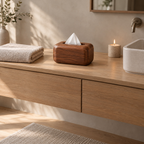 Curved wooden tissue box in Walnut on a 90 cm wide bathroom vanity beside a folded towel with a white tissue pulled through the top opening.