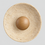 Round travertine disc wall sconce in Natural Wood finish on a light gray studio background